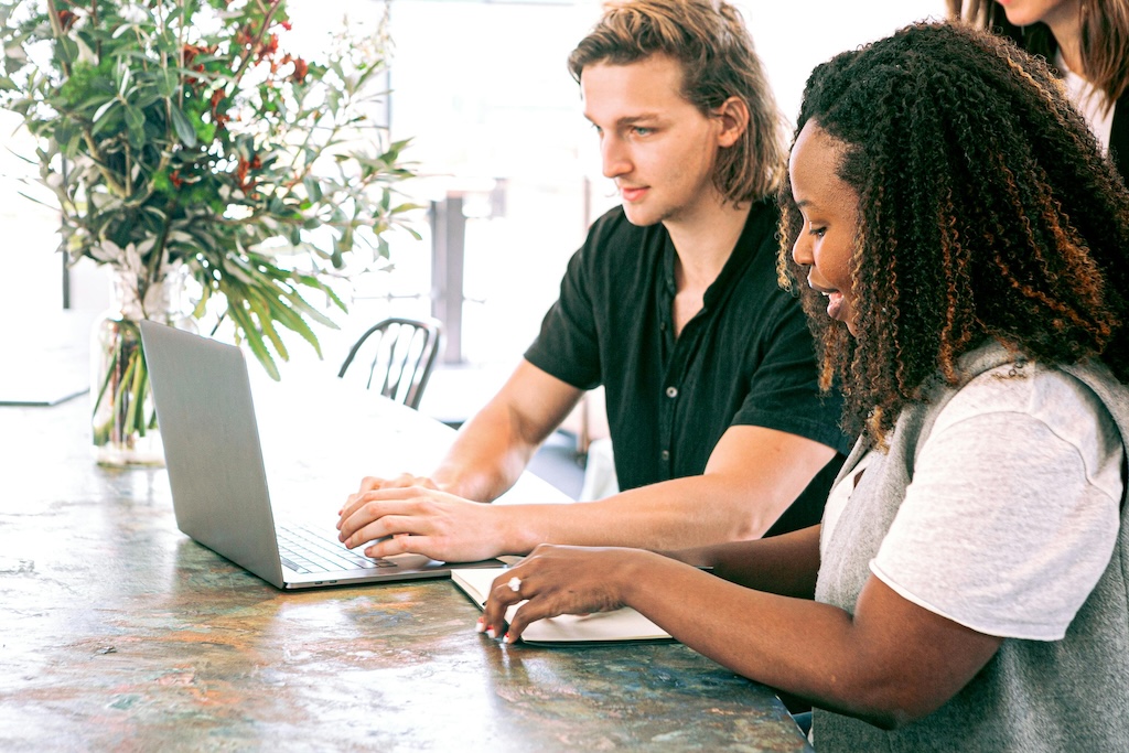 Image of 2 colleagues working together in a sustainable office space.