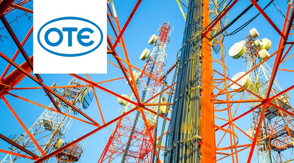 Telecommunications towers with satellite dishes and antennas against a blue sky. OTE group logo appears in a white box on the top left corner.