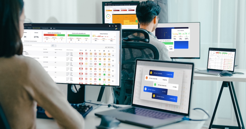 This is a mockup of image of people working at desks with multiple computer screens displaying data dashboards of open source health feature .
