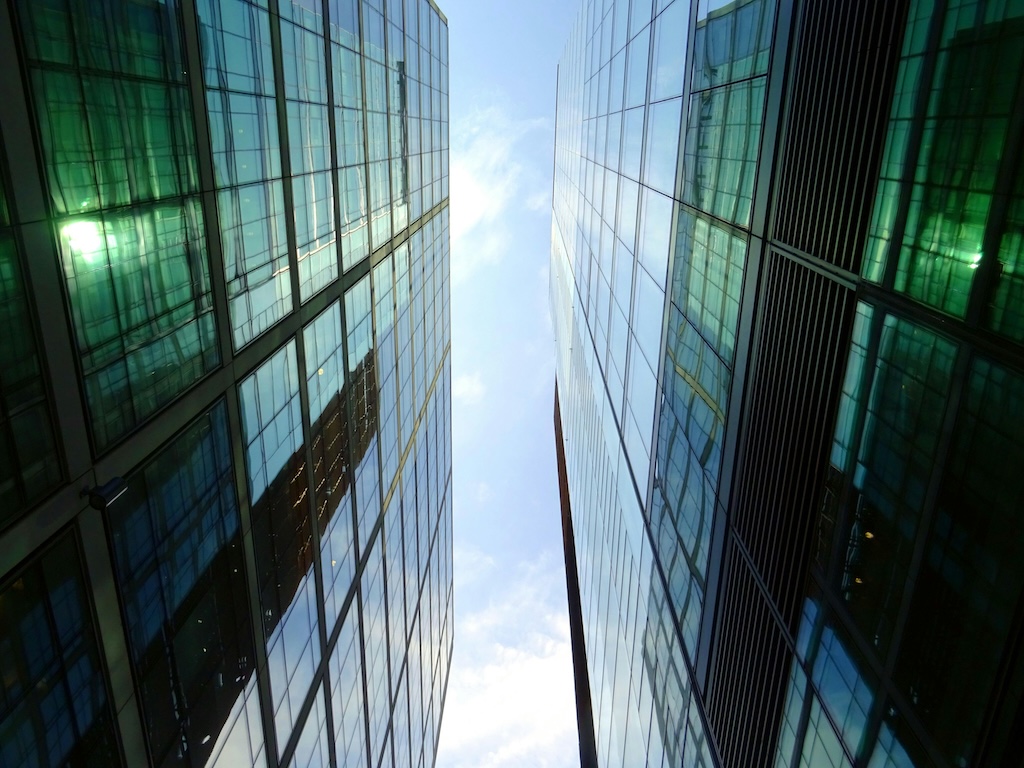 A corporate building shot from the ground-level to give a towering view.