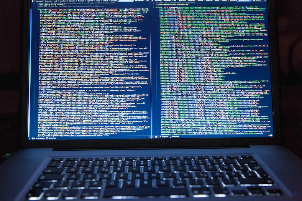 Laptop displaying a lot of lines of code