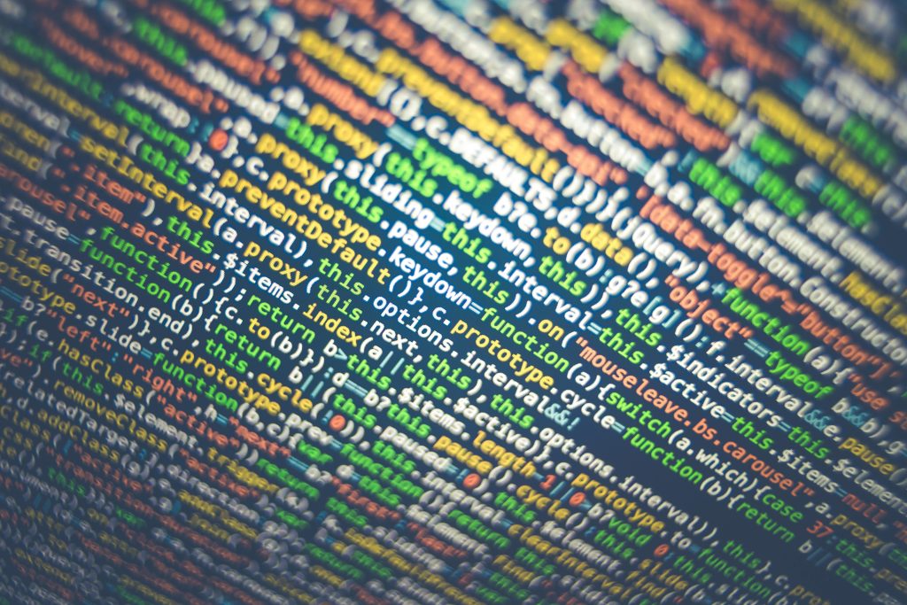 Close-up image of colorful code being displayed on a dark screen