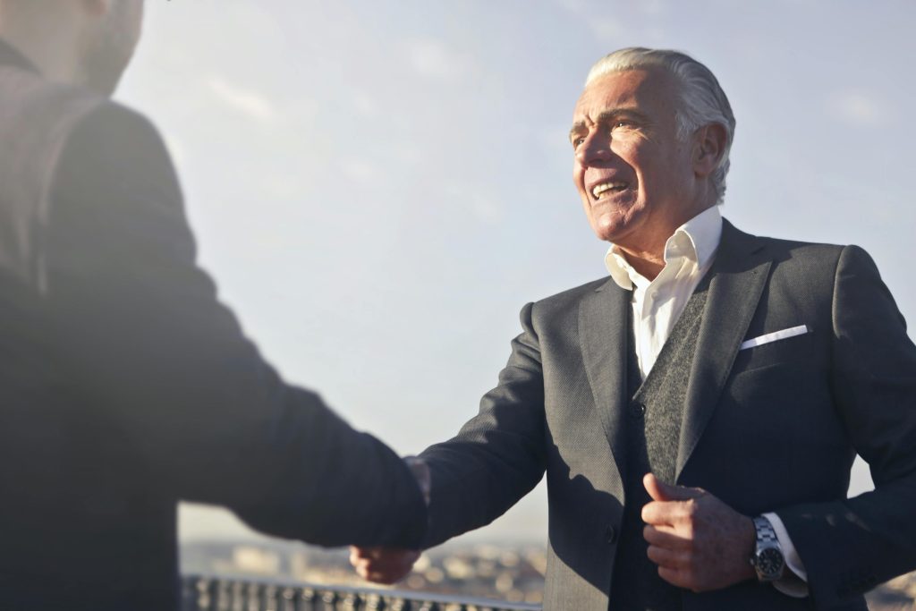 Image of an executive shaking hands with another executive