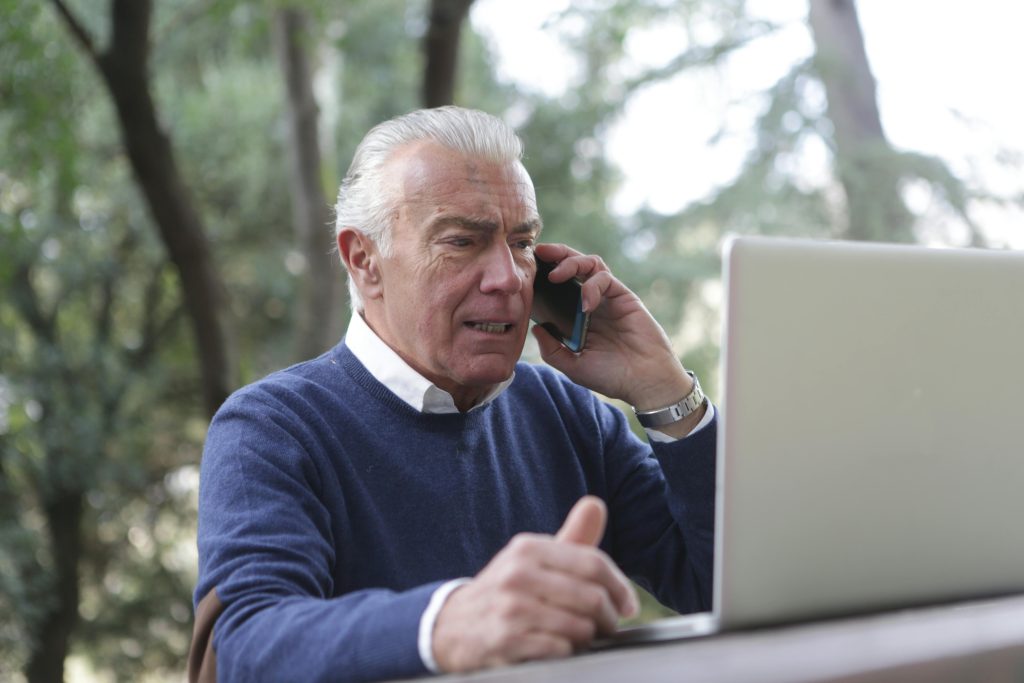 An executive talking on the phone with a serious expression on their face