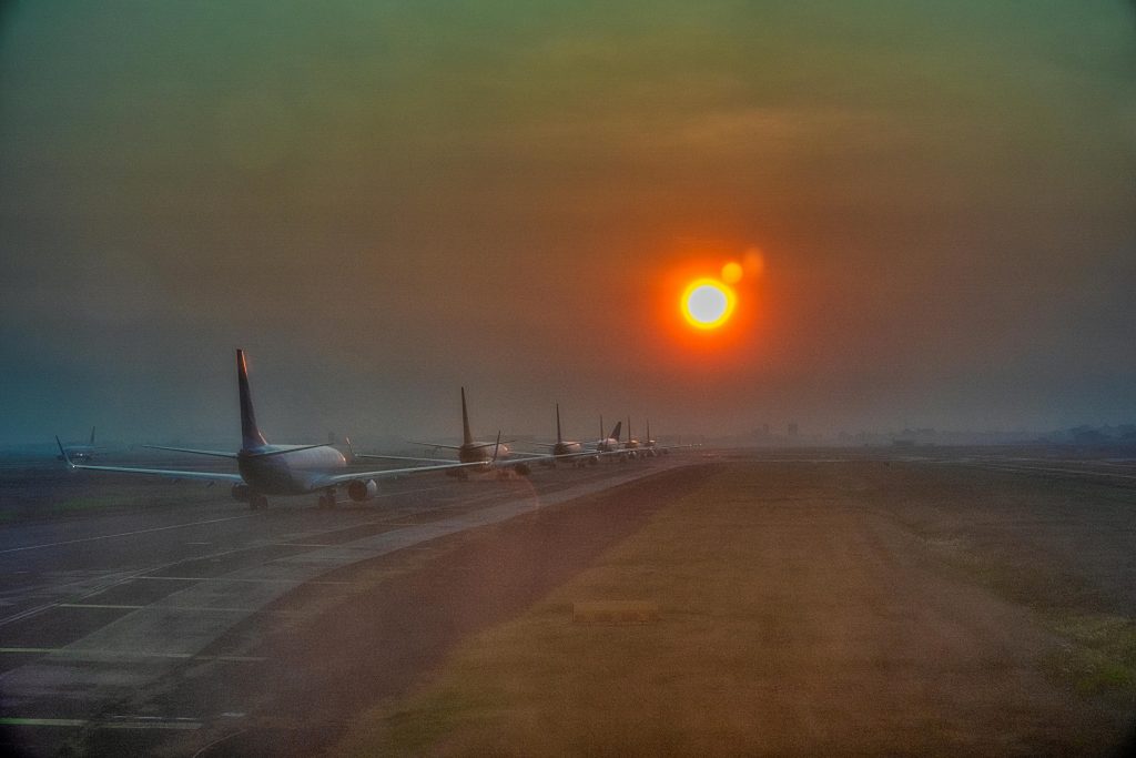 Image of planes on a runway during sunset